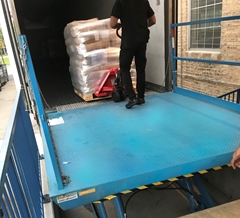 Hydraulic lift used to load and unload product from a truck on a level surface