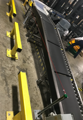 Four zones of a 24 volt Motorized Driven Roller (MDR)  Conveyor which provides separated zones of staged product prior to entering a 90° powered conveyor curve onto a palletizer.