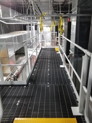 Bar grating being used as floor decking on a mezzanine system.