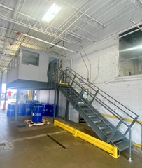 Stairs leading to modular office on top of mezzanine