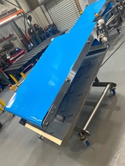 This conveyor is being used to transport raw poultry, pork, and beef to and from an impingement oven.